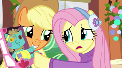 Size: 1280x720 | Tagged: safe, screencap, applejack, fluttershy, earth pony, pegasus, pony, best gift ever, clothes, earmuffs, friendship express, holly the hearths warmer doll, pushing, sweater, sweatershy