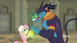 Size: 1920x1080 | Tagged: safe, screencap, ahuizotl, fluttershy, pegasus, pony, daring doubt, discovery family logo, duo, eye contact, female, glowing eyes, hat, looking at each other, male, mare, saddle bag, smiling, surprised, temple, truth talisman