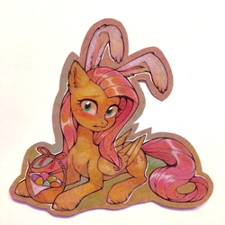 Size: 1000x1000 | Tagged: safe, artist:lispp, fluttershy, pegasus, pony, basket, blushing, bunny ears, cute, ear fluff, easter, easter basket, easter egg, female, folded wings, head turn, holiday, looking at you, mare, prone, shy, shyabetes, solo, traditional art, wings