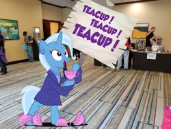 Size: 1200x900 | Tagged: safe, artist:pixelkitties, trixie, human, unicorn, bipedal, clothes, cup, ear piercing, earring, everfree northwest, irl, irl human, jewelry, necklace, photo, photoshop, piercing, ponies in real life, sign, solo, teacup, that pony sure does love teacups