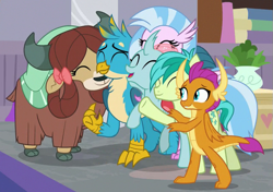 Size: 647x455 | Tagged: safe, derpibooru import, screencap, gallus, ocellus, sandbar, silverstream, smolder, yona, changedling, changeling, classical hippogriff, dragon, earth pony, griffon, hippogriff, pony, yak, the hearth's warming club, bow, cloven hooves, cute, diaocelles, diastreamies, dragoness, female, gallabetes, group hug, hair bow, hug, jewelry, male, monkey swings, necklace, sandabetes, smolderbetes, student six, teenager, yonadorable