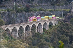 Size: 1023x683 | Tagged: safe, artist:didgereethebrony, derpibooru import, australia, blue mountains, bridge, friendship express, irl, lithgow, mlp in australia, photo, railroad, railway track, signal, train, tree, valley, zig zag railway