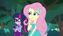 Size: 1280x720 | Tagged: safe, derpibooru import, screencap, fluttershy, sci-twi, twilight sparkle, equestria girls, equestria girls series, text support, text support: fluttershy, female, geode of fauna, geode of telekinesis, glasses, hairpin, phone, ponytail, smiling