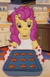 Size: 228x355 | Tagged: safe, screencap, bon bon (g1), pony, g1, my little pony tales, cropped, kitchen, oven mitts, solo