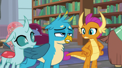 Size: 1280x720 | Tagged: safe, derpibooru import, screencap, gallus, ocellus, smolder, yona, changedling, changeling, dragon, griffon, what lies beneath, bookshelf, dragoness, female, male, trio