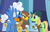 Size: 1042x665 | Tagged: safe, derpibooru import, screencap, fluffy clouds, galena, yuma spurs, griffon, pony, tiger griffon, princess spike (episode), appleloosa resident, background griffon, background pony, bowtie, clothes, cowboy hat, cropped, female, grand equestria pony summit, hat, jacket, male, mare, name tag, raised hoof, spread wings, stallion, trio, wings