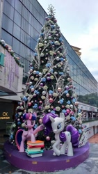 Size: 540x960 | Tagged: safe, derpibooru import, photographer:jakewong, rarity, twilight sparkle, twilight sparkle (alicorn), alicorn, pony, book, calvin klein, christmas, christmas tree, holiday, irl, photo, singapore, statue, tree