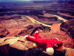 Size: 1080x810 | Tagged: safe, derpibooru import, photographer:peter new, big macintosh, canyon, dead horse, grand canyon, irl, lying, male, on back, photo, playing dead, plushie, smiling, solo, stallion, sunbathing, united states, wordplay