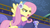 Size: 1280x720 | Tagged: safe, derpibooru import, screencap, fluttershy, pegasus, pony, best gift ever, clothes, earmuffs, female, feminism, flutterbadass, heroic, lidded eyes, mare, open mouth, solo, spread wings, sweater, wings