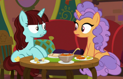 Size: 587x376 | Tagged: safe, screencap, pretzel twist, say cheese, pony, unicorn, the point of no return, background pony, cropped, duo, female, food, looking at each other, mare, sitting, table, the tasty treat