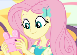 Size: 1494x1080 | Tagged: safe, screencap, fluttershy, better together, equestria girls, holidays unwrapped, camera, canterlot mall, chair, clothes, cropped, cute, dashing through the mall, dress, female, geode of fauna, hairclip, happy, jewelry, looking down, magical geodes, mall, necklace, present, shyabetes, sitting, smiling, solo