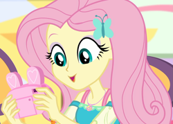 Size: 1511x1080 | Tagged: safe, screencap, fluttershy, equestria girls, equestria girls series, holidays unwrapped, spoiler:eqg series (season 2), camera, canterlot mall, chair, clothes, cropped, cute, dashing through the mall, dress, female, geode of fauna, hairclip, happy, jewelry, looking down, magical geodes, mall, necklace, present, shyabetes, sitting, solo