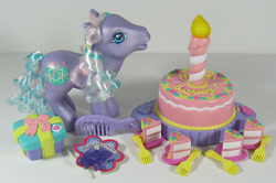 Size: 902x600 | Tagged: safe, photographer:breyer600, razzaroo, pony, g3, birthday cake, box, cake, candle, charm bracelet, comb, cute, food, fork, photo, present, toy