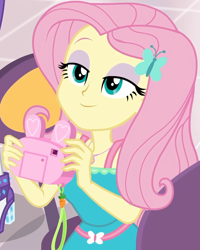 Size: 799x997 | Tagged: safe, screencap, fluttershy, rarity, better together, equestria girls, holidays unwrapped, bunny ears, camera, canterlot mall, clothes, cropped, cute, dashing through the mall, dress, female, flower, geode of fauna, hairclip, happy, jewelry, lidded eyes, looking up, magical geodes, mall, necklace, present, shyabetes, smiling, waistband