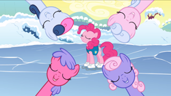 Size: 2880x1620 | Tagged: safe, screencap, lilac links, pinkie pie, earth pony, pony, winter wrap up, background pony, blueberry taffy, eyes closed, female, ice, ice skates, mare, singing, snow, swirly cotton, unnamed pony, weather team, winter wrap up song, winter wrap up vest