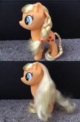 Size: 782x1189 | Tagged: safe, derpibooru import, applejack, earth pony, pony, my little pony: the movie, braid, carpet, long hair, loose hair, toy