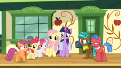 Size: 1366x768 | Tagged: safe, derpibooru import, screencap, biscuit, fluttershy, spur, twilight sparkle, twilight sparkle (alicorn), alicorn, pegasus, pony, growing up is hard to do, box, chest, cmc safe, disappointed, door, neckerchief, ribbon, saddle bag, smiling, squint, train station, unamused, window