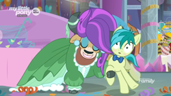 Size: 1366x768 | Tagged: safe, screencap, sandbar, yona, earth pony, pony, yak, she's all yak, alternate hairstyle, blushing, bowl, bowtie, bucket, clothes, cloven hooves, cup, dress, duo, ear piercing, earring, eyeshadow, female, food, jewelry, lemon, makeup, male, pearl earrings, piercing, punch (drink), punch bowl, teenager, wig