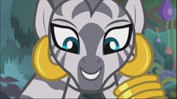 Size: 1369x769 | Tagged: safe, screencap, zecora, zebra, she talks to angel, close-up, cropped, crouching, ear piercing, earring, female, jewelry, leg rings, looking at you, mare, piercing, smiling, solo