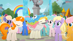 Size: 1699x956 | Tagged: safe, screencap, kersplash, earth pony, fish, pony, unicorn, rainbow roadtrip, animal costume, background pony, clothes, costume, discovery family logo, eyes closed, female, fish costume, fountain, harmonica, hope hollow, male, mare, musical instrument, outdoors, playing instrument, rainbow, rainbow trout (character), stallion, statue, tree, unnamed pony