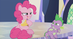 Size: 1600x864 | Tagged: safe, derpibooru import, screencap, pinkie pie, spike, dragon, earth pony, pony, the last laugh, cupcake, eating, food, munching, plastic, silly, silly pony, sitting, table, twilight's castle, weirded out, winged spike