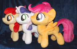 Size: 1280x824 | Tagged: safe, artist:peruserofpieces, apple bloom, scootaloo, sweetie belle, earth pony, pegasus, pony, unicorn, accessory, bow, cutie mark crusaders, female, filly, happy, horn, irl, photo, plushie, profile, ribbon, side by side, smiling, toy, trio, wings