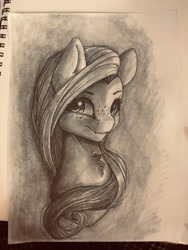 Size: 3024x4032 | Tagged: safe, artist:miokomata, fluttershy, pegasus, pony, bust, chest fluff, fangs, female, freckles, freckleshy, grayscale, irl, looking at you, mare, monochrome, photo, sketch, sketchbook, traditional art