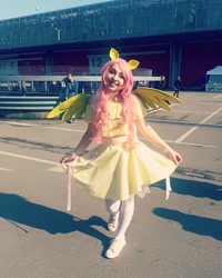 Size: 1080x1350 | Tagged: safe, derpibooru import, fluttershy, human, clothes, cosplay, costume, curtsey, cutie mark, cutie mark on clothes, dress, female, irl, irl human, photo, shoes, wings