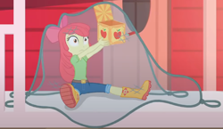 Size: 1482x857 | Tagged: safe, screencap, apple bloom, better together, equestria girls, holidays unwrapped, adorabloom, apple bloom's bow, boots, bow, box, caught, clothes, cropped, cute, hair bow, house, jack in the box, jack-in-the-box, jeans, lifting, net, pants, shirt, shoes, sitting, solo, surprised, the cider louse fools