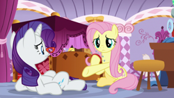 Size: 1920x1080 | Tagged: safe, derpibooru import, screencap, fluttershy, rarity, pegasus, pony, unicorn, dragon dropped, bed, duo, female, frown, glasses, hoof hold, mare, on back, pincushion, rarity's glasses, underhoof