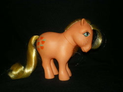 Size: 640x480 | Tagged: safe, photographer:lancer, applejack (g1), g1, black background, bow, simple background, tail bow, toy