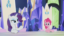 Size: 1280x720 | Tagged: safe, derpibooru import, screencap, pinkie pie, rarity, earth pony, pony, unicorn, memories and more, spoiler:memories and more, spoiler:mlp friendship is forever, 9now, bedroom eyes, duo, mid-blink screencap, sitting, smiling, smug