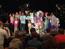 Size: 1024x768 | Tagged: safe, artist:whiteheather, derpibooru import, human, 2014, auction, cathy weseluck, charity, convention, everfree northwest, irl, irl human, marÿke hendrikse, photo, quilt, stage