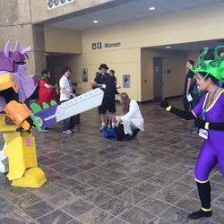 Size: 640x640 | Tagged: safe, artist:guardlove123, artist:whiteboygus, derpibooru import, mane-iac, human, 2014, bronycon, convention, cosplay, fight, irl, irl human, megazord, photo, sign