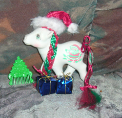 Size: 901x870 | Tagged: safe, artist:fizzy--love, g1, bow, comb, hat, irl, merry treat, photo, present, santa hat, solo, tail bow, toy