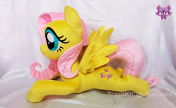 Size: 903x555 | Tagged: safe, artist:trashkitten-plushies, derpibooru import, fluttershy, pegasus, irl, lying down, photo, plushie, watermark