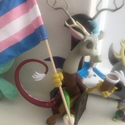 Size: 1080x1080 | Tagged: safe, derpibooru import, discord, draconequus, chair, cup, duo, eyes closed, flag, horns, irl, male, photo, pride, pride flag, sitting, toy, transgender pride flag, wings