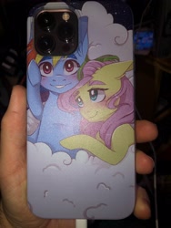 Size: 3024x4032 | Tagged: safe, artist:silbersternenlicht, derpibooru import, fluttershy, rainbow dash, pegasus, pony, female, flutterdash, iphone case, iphone12maxpro, lesbian, phone case, photo, shipping, shipping fuel