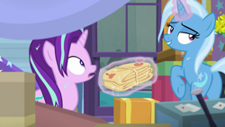 Size: 1280x720 | Tagged: safe, derpibooru import, screencap, starlight glimmer, trixie, pony, road to friendship, bedroom eyes, duo, glowing horn, horn, indoors, lidded eyes, magic, magic aura, trixie's wagon, we're friendship bound, wet, wet mane