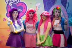 Size: 912x608 | Tagged: safe, derpibooru import, fluttershy, pinkie pie, rainbow dash, rarity, human, equestria girls, clothes, dancing, eqg el show en vivo, equestria girls logo, irl, irl human, legs, live action, photo