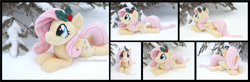 Size: 5340x1754 | Tagged: safe, artist:peruserofpieces, derpibooru import, fluttershy, pegasus, pony, beanie (plushie), cute, female, happy, holly, irl, looking at you, lying down, mare, photo, plushie, prone, shyabetes, smiling, smiling at you, snow, solo, sploot, tree, wings