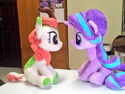 Size: 1024x768 | Tagged: safe, artist:nekokevin, autumn blaze, starlight glimmer, kirin, pony, unicorn, series:nekokevin's glimmy, calendar, cloven hooves, duo, female, irl, looking at each other, mare, photo, plushie, sitting, table, underhoof