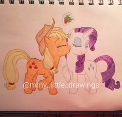 Size: 1080x1033 | Tagged: safe, artist:mmy_little_drawings, derpibooru import, applejack, rarity, earth pony, pony, unicorn, eyelashes, eyes closed, female, freckles, glowing horn, hat, holly, holly mistaken for mistletoe, horn, kiss on the cheek, kissing, lesbian, magic, mare, raised hoof, raised leg, rarijack, shipping, telekinesis, traditional art, watermark