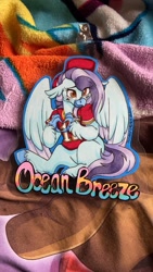 Size: 675x1200 | Tagged: safe, artist:twisted-sketch, derpibooru import, oc, oc:ocean breeze, hippogriff, badge, blanket, blushing, claws, clothes, football, hat, hippogriff oc, irl, jersey, kansas city chiefs, photo, sports, traditional art, wings