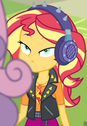 Size: 1920x2798 | Tagged: safe, derpibooru import, screencap, sunset shimmer, sweetie belle, equestria girls, equestria girls series, overpowered (equestria girls), clothes, cropped, cutie mark, cutie mark on clothes, female, geode of empathy, hallway, headphones, high res, jacket, jewelry, leather, leather jacket, lidded eyes, lockers, magical geodes, necklace, solo focus