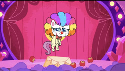 Size: 828x473 | Tagged: safe, derpibooru import, screencap, fluttershy, pegasus, pony, lolly-pop, my little pony: pony life, spoiler:pony life s02e19, apple, bowtie, breaking the fourth wall, clown, clown makeup, clown nose, clown wig, cute, female, flutterclown, flying, food, rainbow wig, red nose, shyabetes, solo, stage