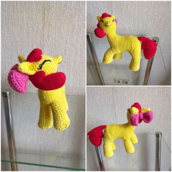 Size: 1448x1448 | Tagged: safe, artist:woodiewool, derpibooru import, apple bloom, earth pony, pony, amigurumi, crochet, eyes closed, female, filly, glass table, handmade, irl, photo, plushie, smiling, solo