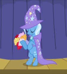Size: 652x720 | Tagged: safe, derpibooru import, screencap, trixie, pony, unicorn, boast busters, season 1, bipedal, bouquet, cape, clothes, cropped, curtains, eyes closed, flower, hat, smiling, solo, stage, stars, trixie's cape, trixie's hat