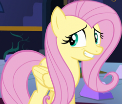 Size: 867x737 | Tagged: safe, derpibooru import, screencap, fluttershy, pegasus, pony, party pooped, season 5, cropped, female, grin, mare, nervous, nervous grin, smiling