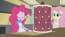 Size: 3410x1920 | Tagged: safe, derpibooru import, screencap, fluttershy, pinkie pie, acadeca, equestria girls, friendship games, apron, cake, clothes, female, food, hairpin, smiling, tanktop